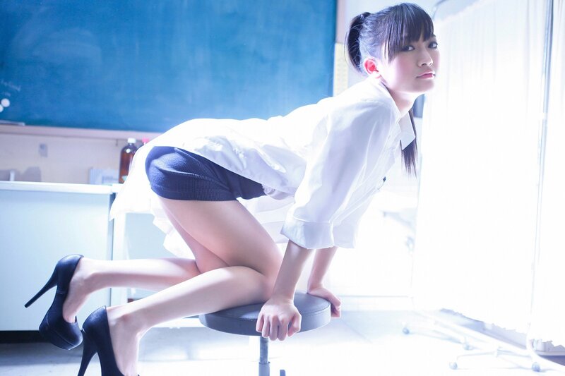 woman in school uniform on stool