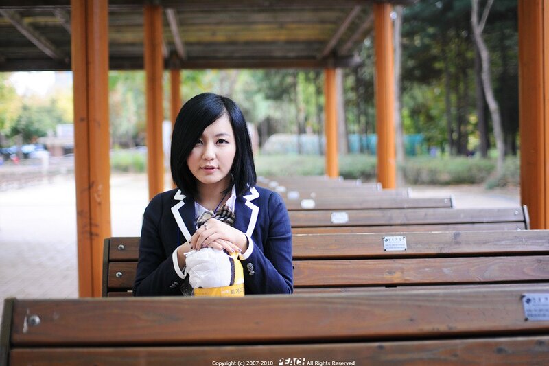 woman in school uniform sitting