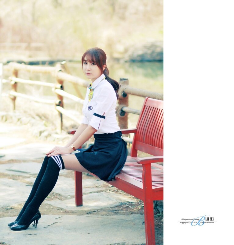 woman in school uniform sitting