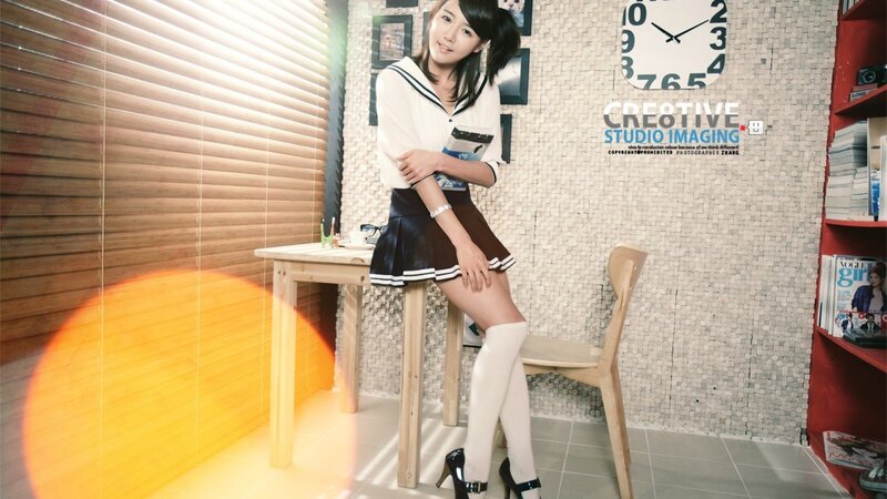 woman in school uniform sitting