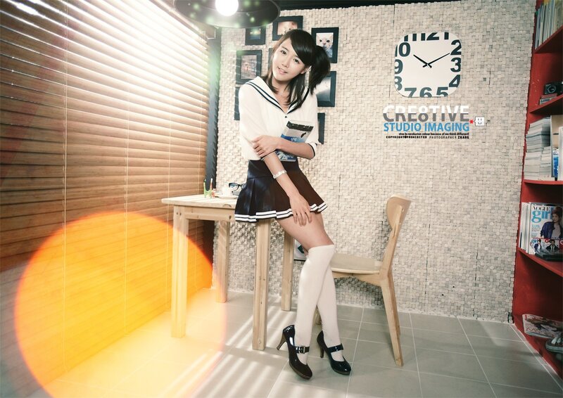 woman in school uniform sitting at desk