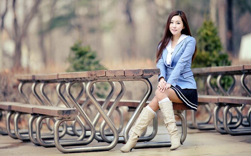 woman in school uniform sitting on bench