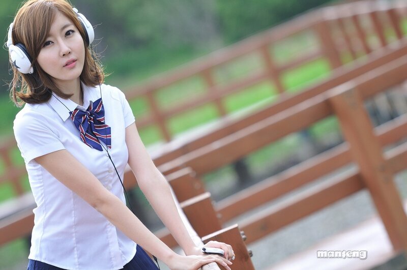 woman in school uniform with headphones
