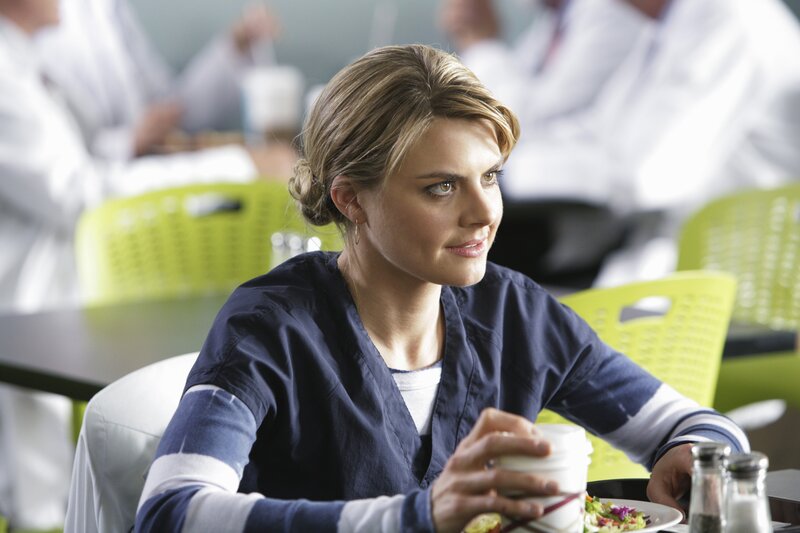 woman in scrubs at cafeteria