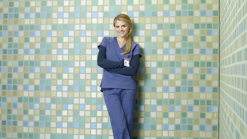 woman in scrubs smiling
