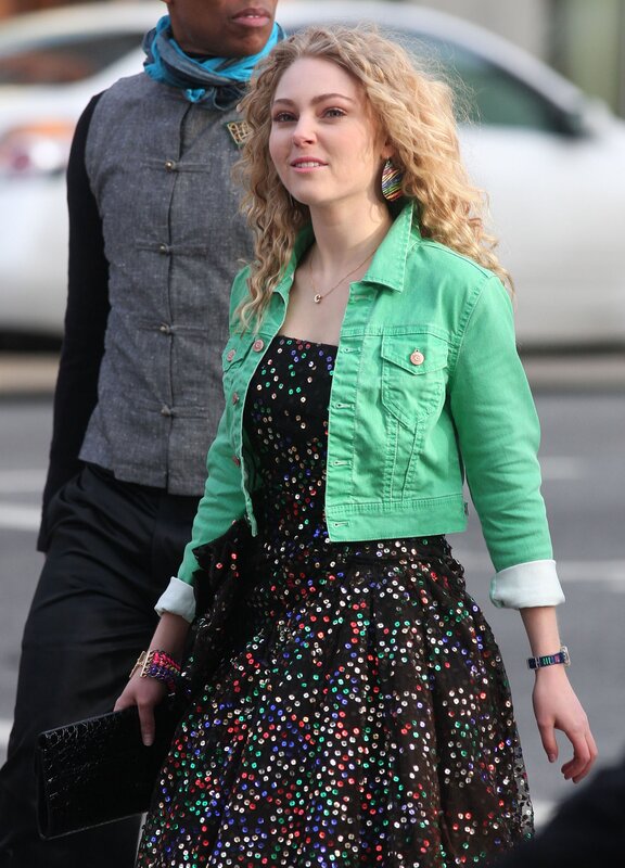 Woman in sequin dress and green jacket