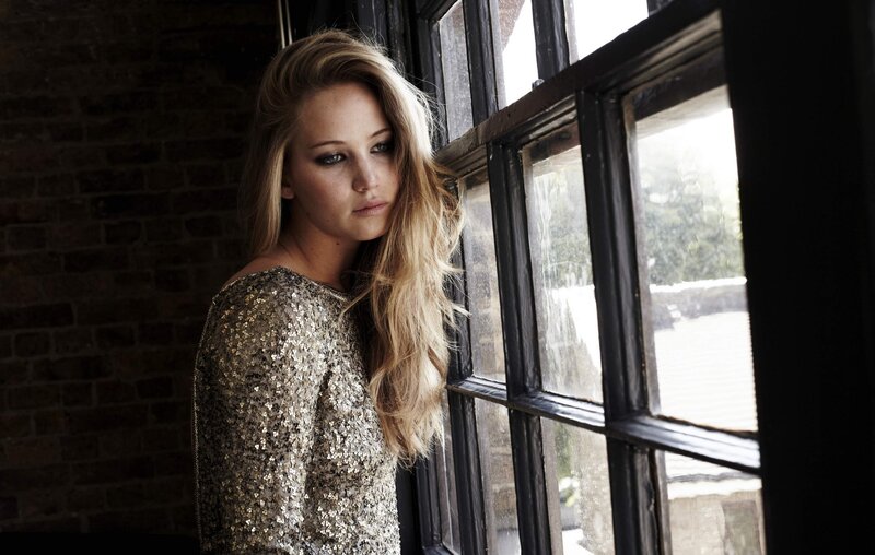 woman in sequin dress by window