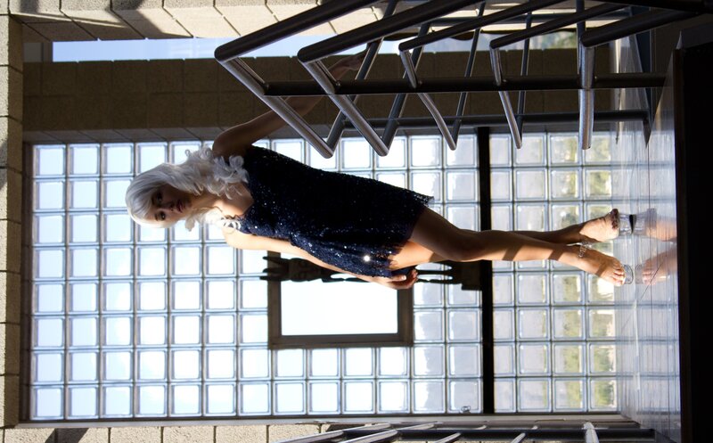 woman in sequin dress on staircase