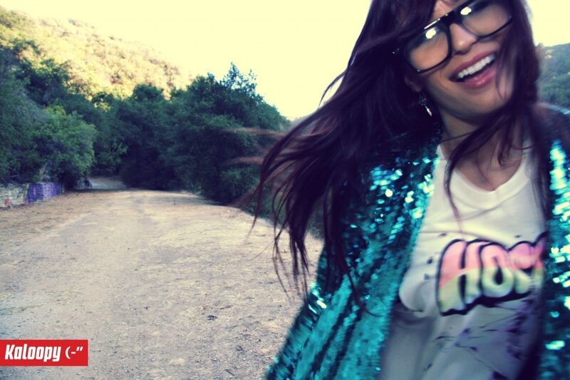 woman in sequin jacket smiling