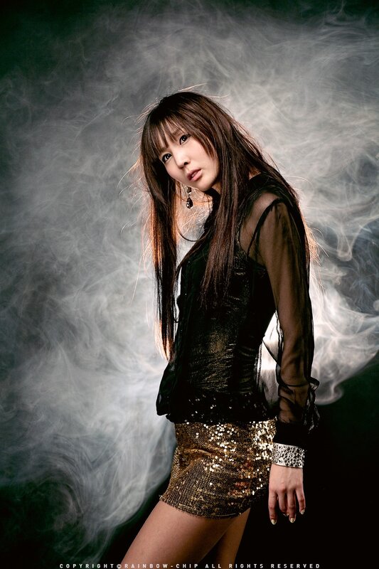 woman in sequin skirt with smoke