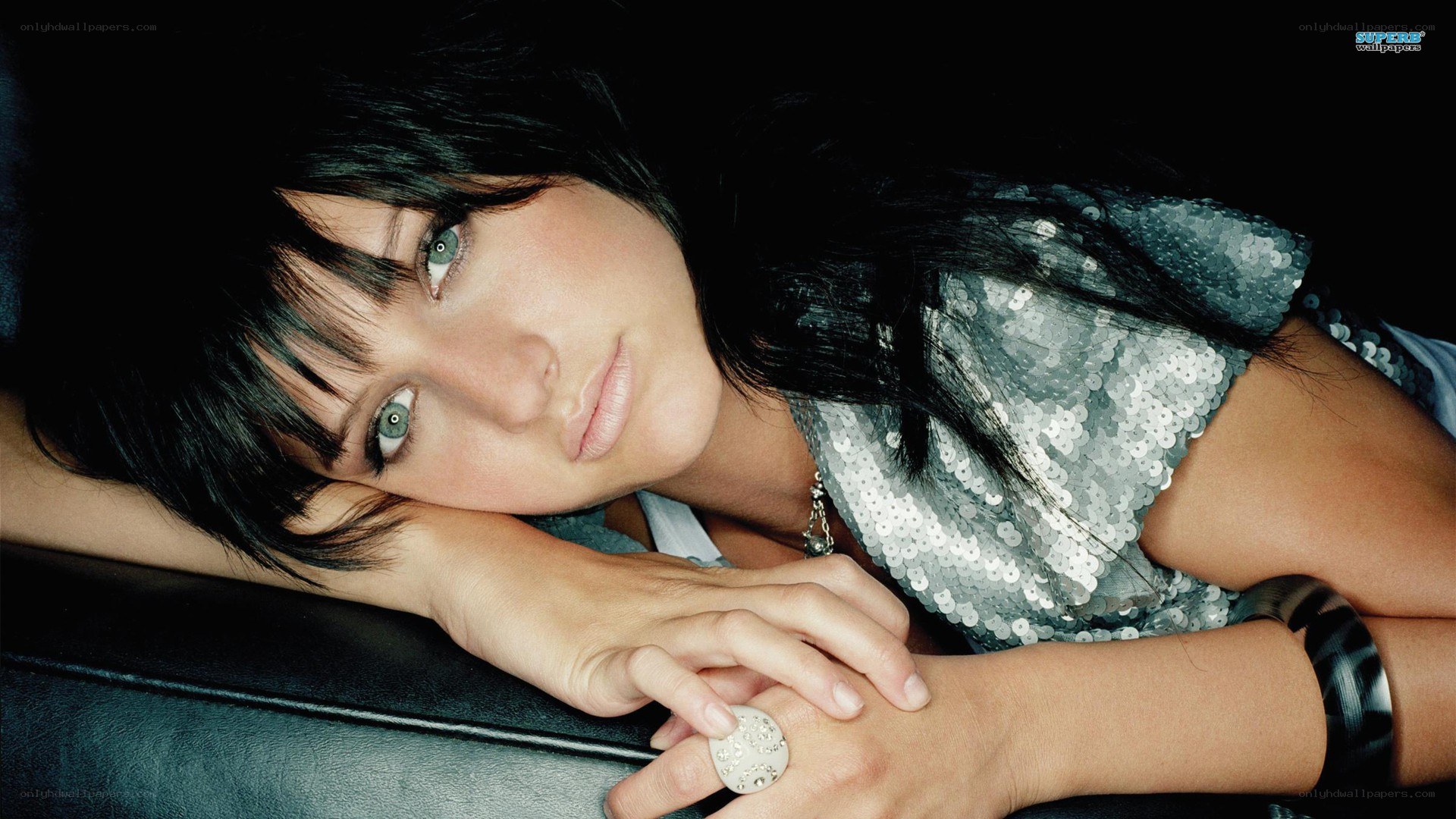 woman in sequin top resting