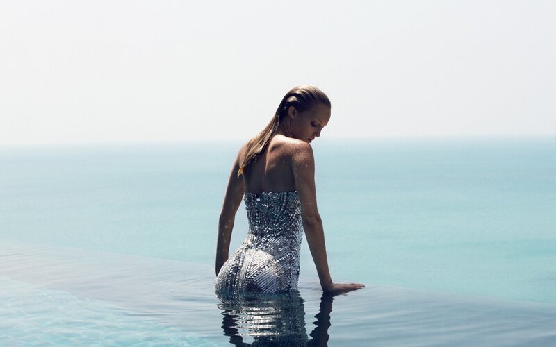 woman in sequined dress at infinity pool