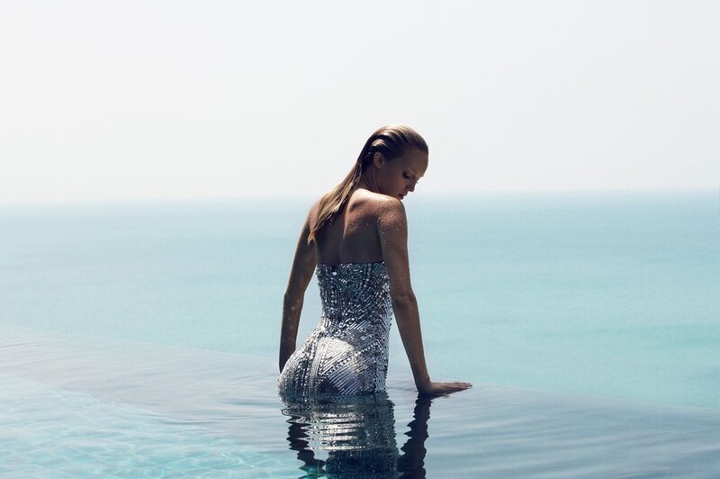 Woman in sequined dress at infinity pool