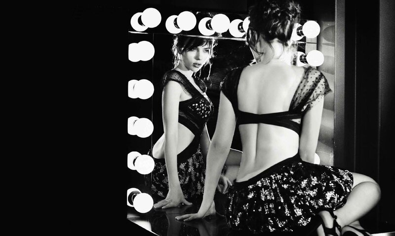 Woman in sequined dress at mirror