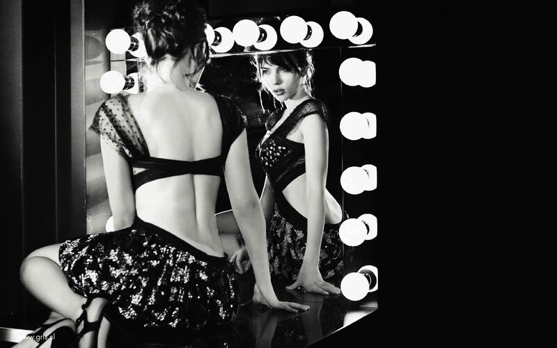 woman in sequined dress at mirror