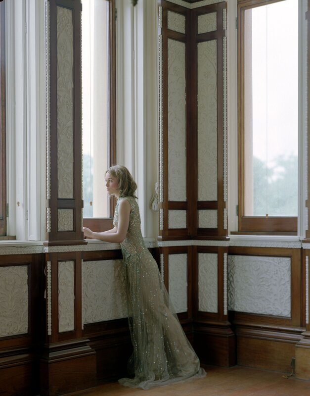 woman in sequined dress by window