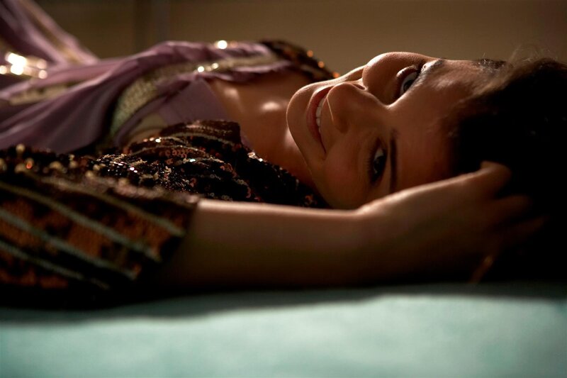 woman in sequined dress lying down