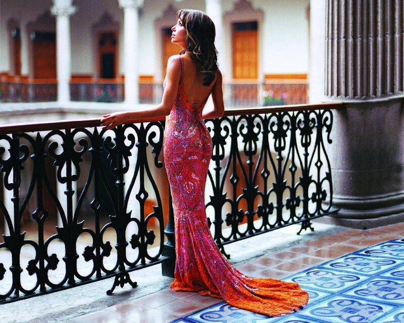 woman in sequined gown on balcony
