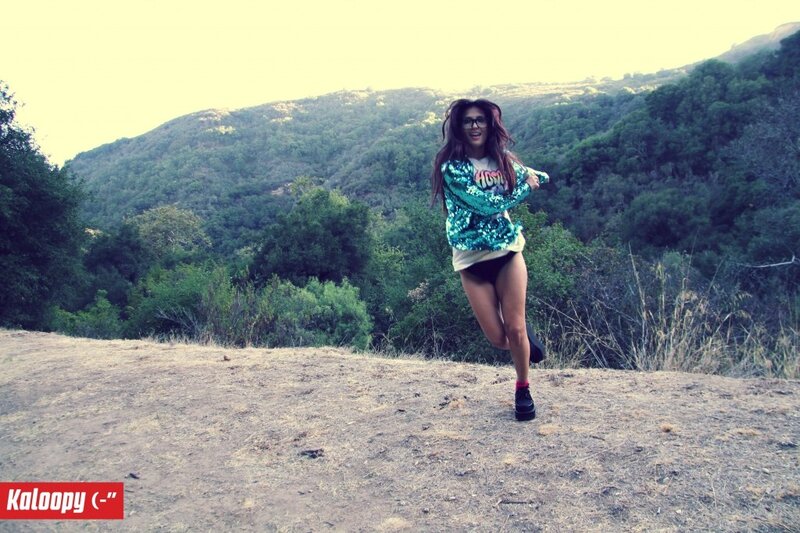woman in sequined jacket on hill