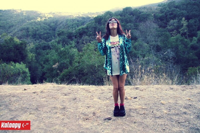 Woman in sequined jacket outdoors