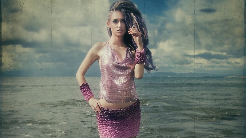 woman in sequined outfit at beach