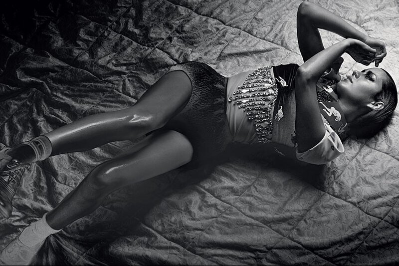 woman in sequined outfit lying on bed