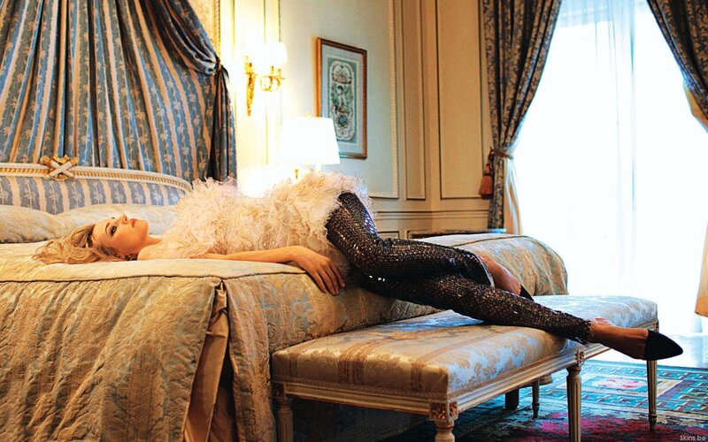Woman in sequined pants on a bed