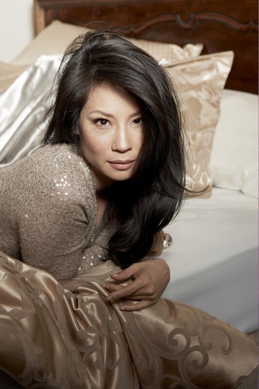 woman in sequined sweater on bed