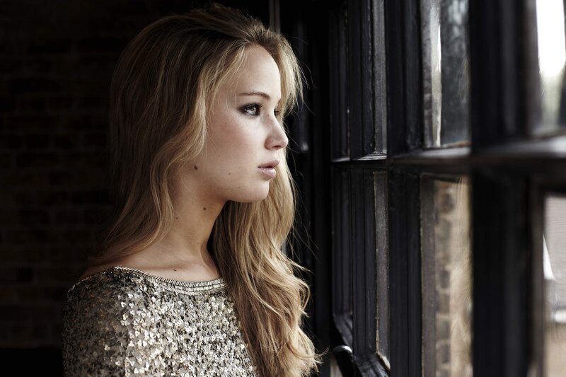 woman in sequins looking out window