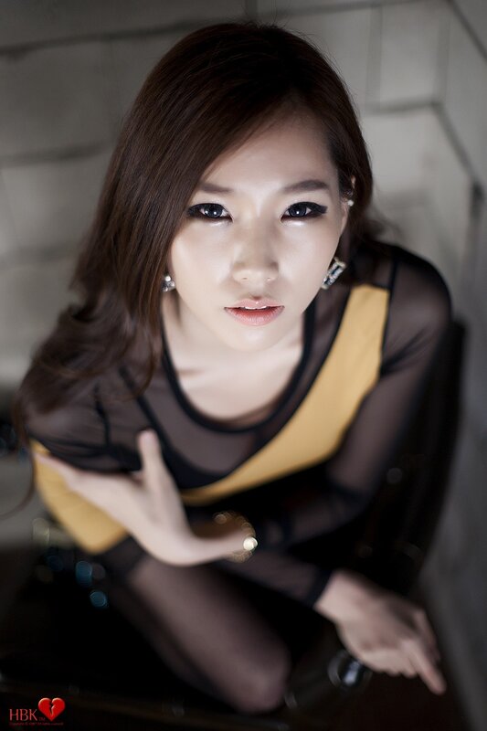 woman in sheer top looking up