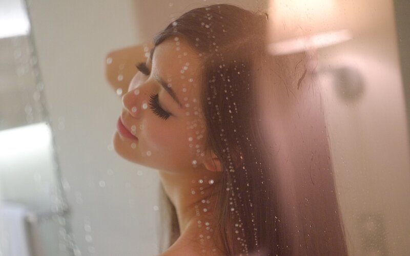 woman in shower with water droplets