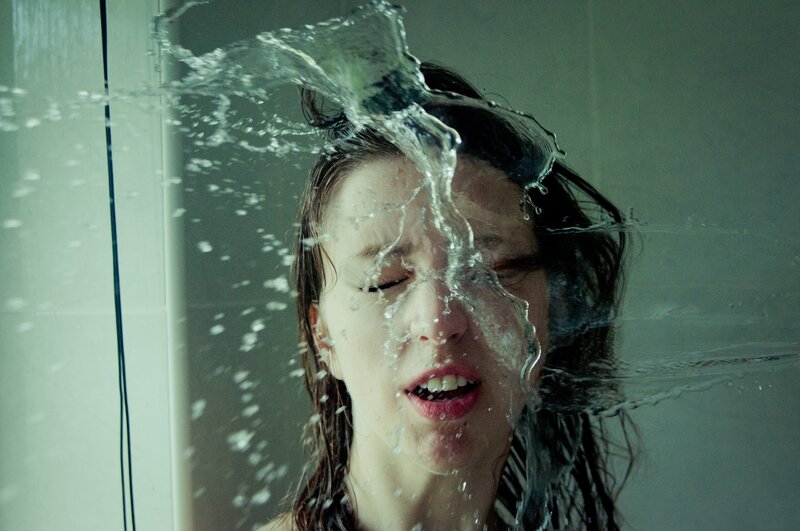 woman in shower with water splashing