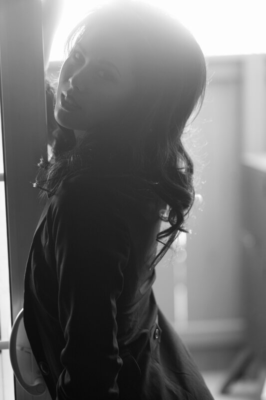 woman in silhouette by window