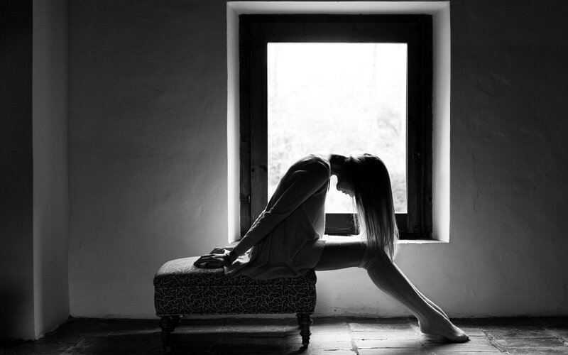 woman in silhouette by window