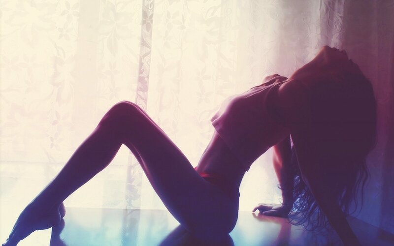 woman in silhouette by window
