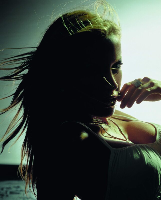 woman in silhouette with hand to face