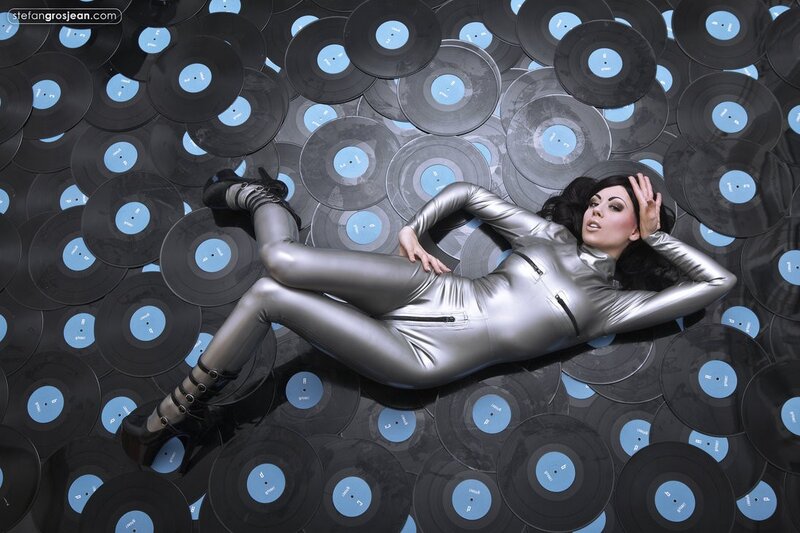 woman in silver bodysuit on records