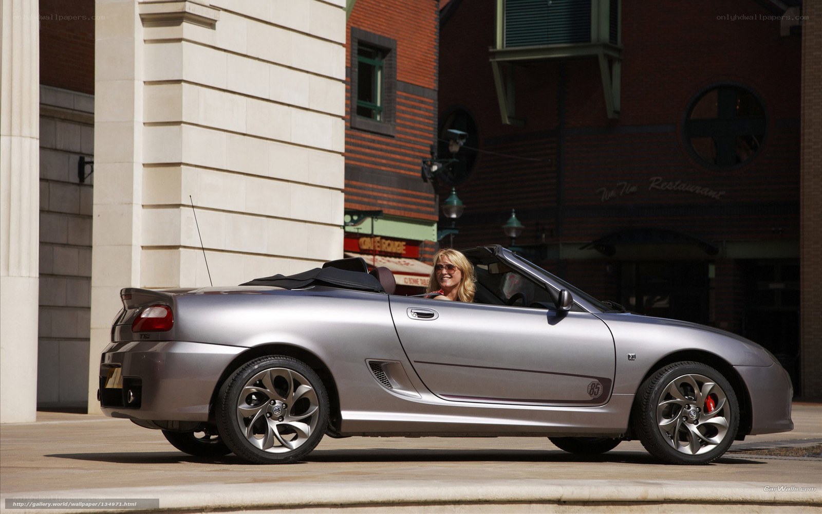 Woman in silver convertible car