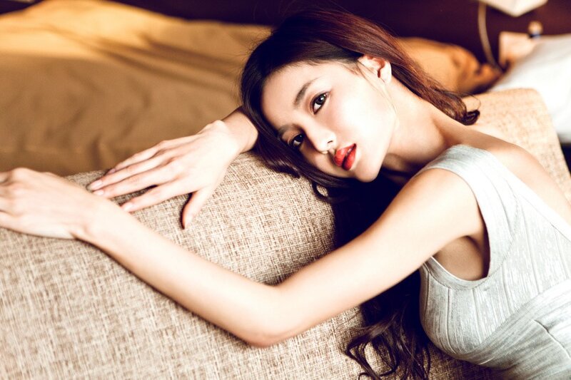 woman in silver dress lying on sofa