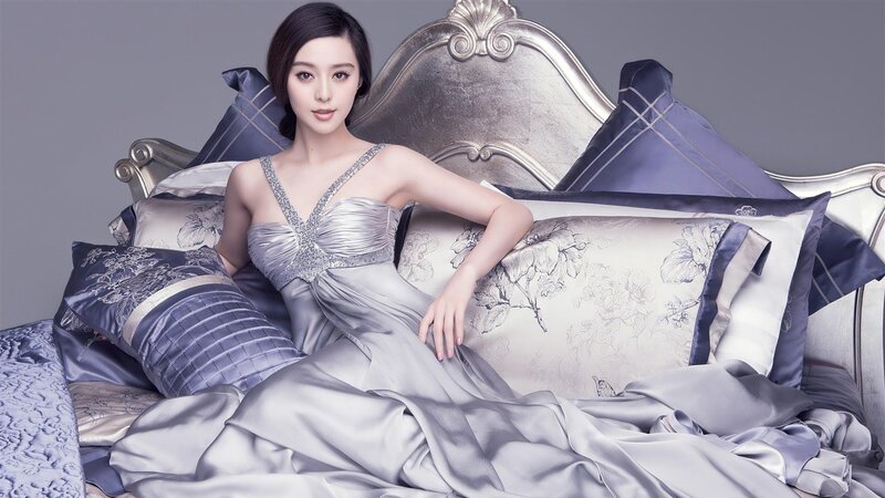woman in silver dress on bed