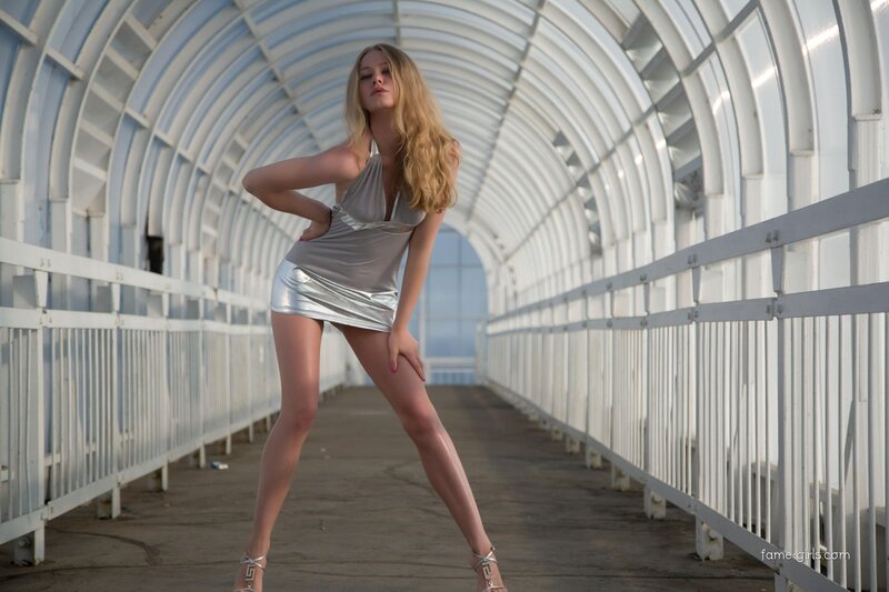 Woman in silver dress on bridge