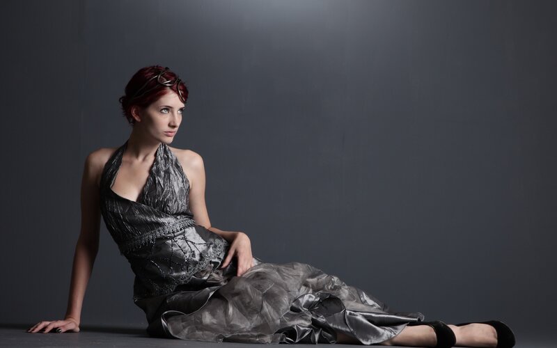 woman in silver dress sitting