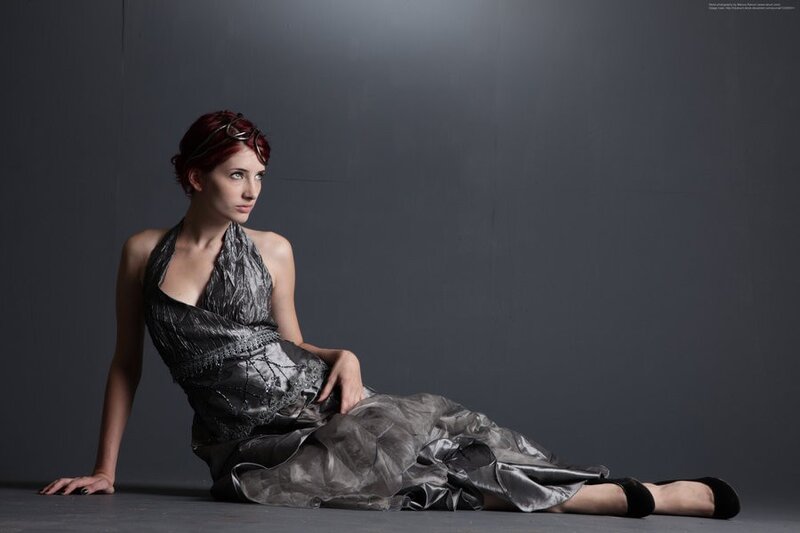 woman in silver dress sitting