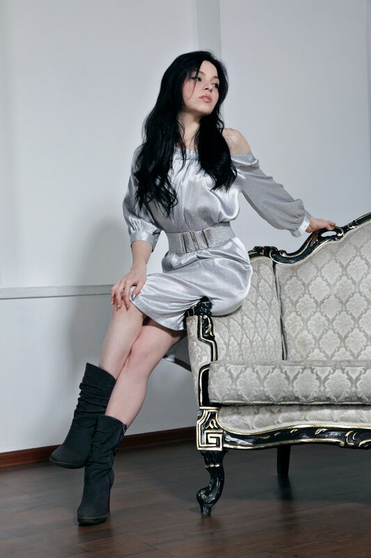 woman in silver dress sitting on sofa
