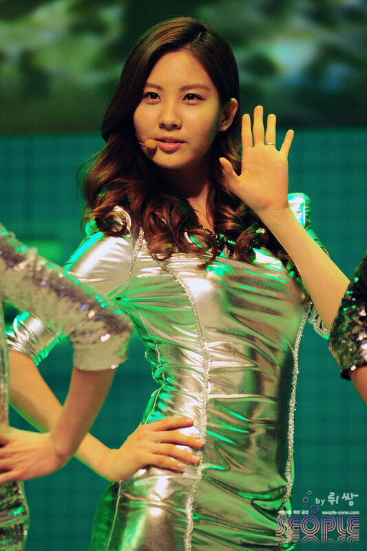 woman in silver dress waving