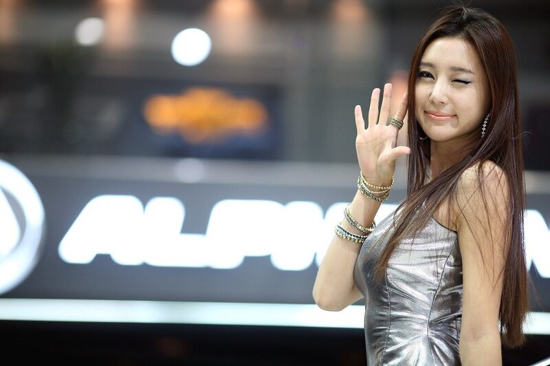 woman in silver dress waving