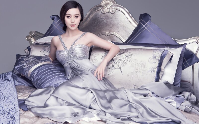 woman in silver gown on bed