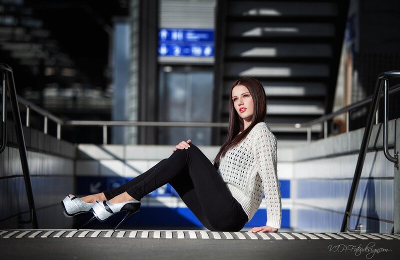 woman in silver heels sitting