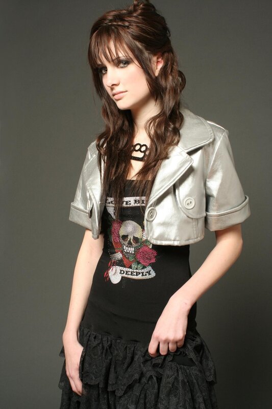 Woman in silver jacket and skull top