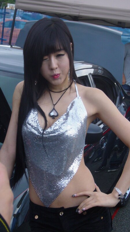 woman in silver top at car show